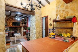 a kitchen with a table with a bowl of fruit on it at La Cuina De Paqui in Caserío Calandari
