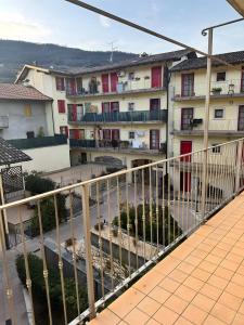 a balcony of a building with buildings in the background at La Masera sul Torrente By Immobilux in Mori