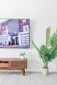 a wooden bench in a room with a painting on the wall at 2bd Suite Steps To Beach! - Private Patio & Grill! in Oceanside