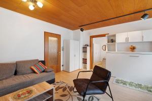 a living room with a couch and a chair at Ferienwohnung Eva Maria in Pforzheim