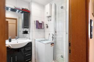 a white bathroom with a sink and a shower at Ferienwohnung Eva Maria in Pforzheim +21 photos