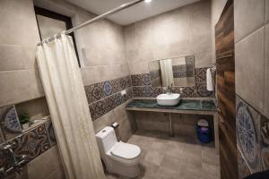 a bathroom with a toilet and a sink at Bajoon homestay in Bhīm Tāl