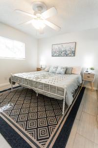 a bedroom with a bed with a ceiling fan at 2bd Suite Steps To Beach! - Private Patio & Grill! in Oceanside