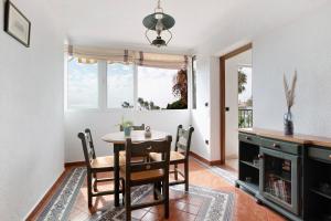 a dining room with a table and chairs and a window at Casa Torremuelle in Benalmádena