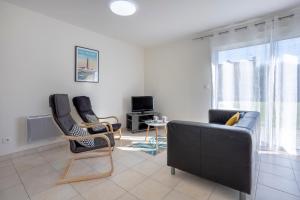 a living room with a couch and two chairs at La Pause Bigoudène in Penmarch