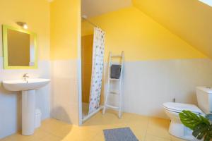 a bathroom with a sink toilet and a shower at La Pause Bigoudène in Penmarch +18 photos