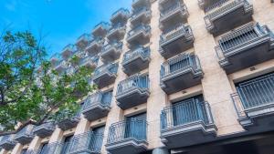 an apartment building with balconies on the side of it at Costacabana - Apartment Dali in Lloret de Mar +4 photos
