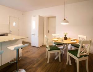 a kitchen and dining room with a table and chairs at Petit Castanyer in Viladrau