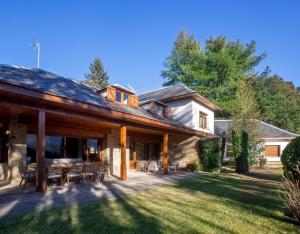 a large house with a patio and lawn at Petit Castanyer in Viladrau