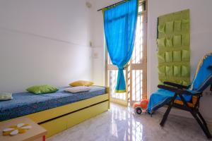a bedroom with a bed and a chair and a window at Villa Rita a 200m dal mare in I Bacini