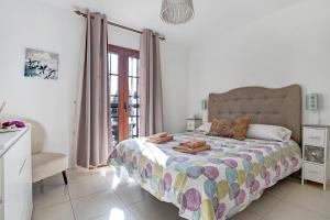 a bedroom with a bed and a window at Puerto Chico P in Playa Blanca +18 photos