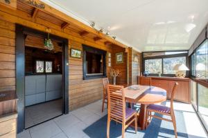 a kitchen and dining room with a table and chairs at Chalet de Monique in Le Val-dʼAjol