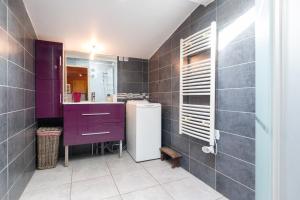 a bathroom with a purple vanity and a sink at Chalet de Monique in Le Val-dʼAjol +14 photos