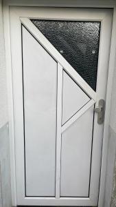 a white garage door with a window on it at Das grüne Haus in Finsterwalde +7 photos