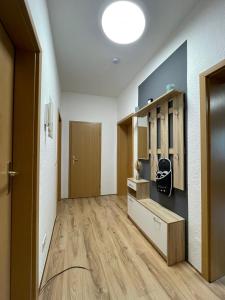 a room with a hallway with wooden floors and a door at Das grüne Haus in Finsterwalde