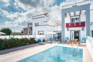a view of a house with a swimming pool at Blue Pearl in Lachania