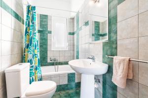 a bathroom with a white toilet and a sink at Blue Pearl in Lachania +24 photos