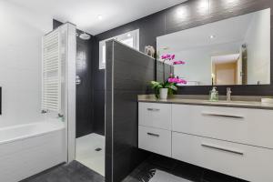 a bathroom with a sink and a tub and a mirror at Casa con jardín próxima a Barcelona in Sant Andreu de Llavaneres +30 photos