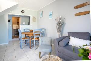 a living room with a couch and a table at Joisalig in Saint-Quay-Portrieux