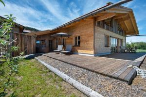 a house with a wooden deck in front of it at Bergchalet 3 in Freyung