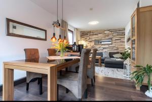 a dining room and living room with a table and chairs at Haus Laffina in Büsum