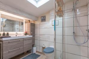 a bathroom with a shower and a toilet and a sink at Studio 404 in Le Muy