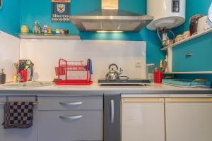 a kitchen with blue walls and a counter top at Studio 404 in Le Muy +12 photos