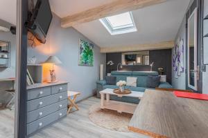 a living room with a blue couch and a table at Studio 404 in Le Muy