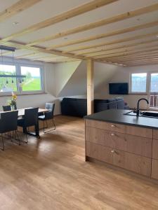 a kitchen and living room with a table and chairs at Ferienhaus am Kapellenhof in Triberg