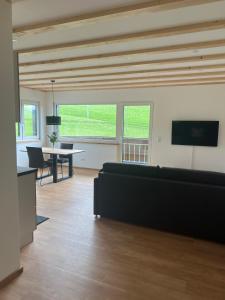 a living room with a couch and a table at Ferienhaus am Kapellenhof in Triberg