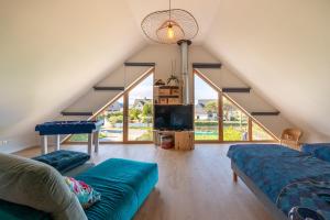 a living room with a couch and a pool table at Gite Familiale ty laouen in Sarzeau