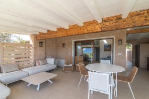 a living room with a couch and a table at Villa Cactus, Costa Corallina in Olbia