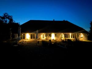 a house lit up at night with lights at Ferienwohnung auf dem Wald 4 Per in Görwihl