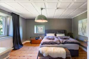 a bedroom with a large bed and a ceiling at Ferienwohnung auf dem Wald 4 Per in Görwihl