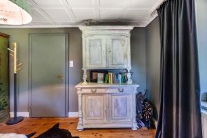 a wooden cabinet with books on it in a room at Ferienwohnung auf dem Wald 4 Per in Görwihl +9 photos