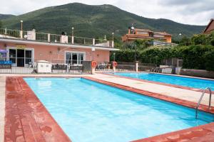 a large swimming pool in front of a house at Monolocale con soppalco 43 in Albenga