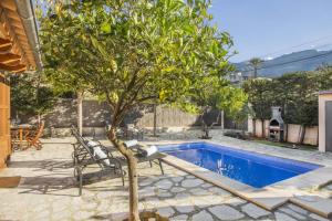 a small tree next to a swimming pool at Ca'n Doi in Sóller