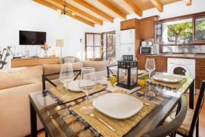 a living room with a table with wine glasses on it at Ca'n Doi in Sóller
