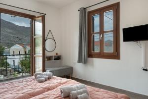 a bedroom with a bed and a large window at Thea home Symi in Symi