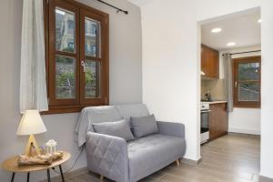 a living room with a couch and a table at Thea home Symi in Symi