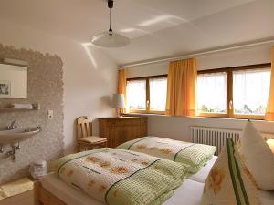 a bedroom with two beds and a sink in it at Gasthaus Zur Linde Ferienwohnungen in Oberharmersbach