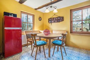 a kitchen with a red refrigerator and a table and chairs at Kleiner Eselhof in Semlow +23 photos