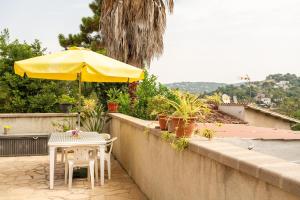 a table and chairs and an umbrella on a patio at Gesgroup in Lloret Blau