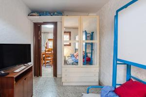 a bedroom with a bunk bed and a tv at Gesgroup in Lloret Blau +12 photos