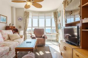 a living room with a couch and a tv at Apartamento Lance del Sol in Fuengirola