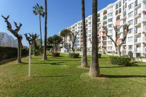 a park with palm trees in front of a building at Apartamento Lance del Sol in Fuengirola