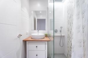 a white bathroom with a sink and a shower at Oasis de Valencia in Valencia +23 photos