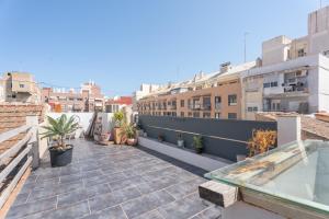a balcony with plants and a swimming pool on a building at Oasis de Valencia in Valencia