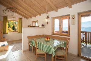 a kitchen and dining room with a table and chairs at Pföslhof in Laives +26 photos