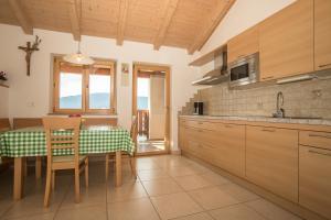 a kitchen with a table and a dining room at Pföslhof in Laives